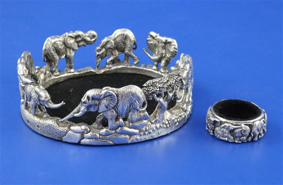 A modern Zimbabwean cast sterling silver wine coaster and similar bottle collar by Patrick Mavros, coaster 5in at widest point.